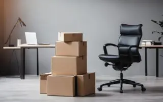 Stack of cardboard boxes and office chair in an empty office room, symbolizing moving to a new home office.