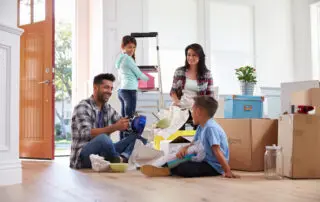 Family Moving Into New Home unpacking moving boxes
