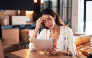 Worry, woman and reading document at new house for property purchase, agreement and hidden fees. Concern, female person and contract with legal terms, lease cost and review information for relocation.