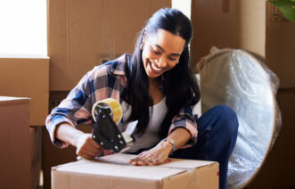 woman packing a moving essentials box